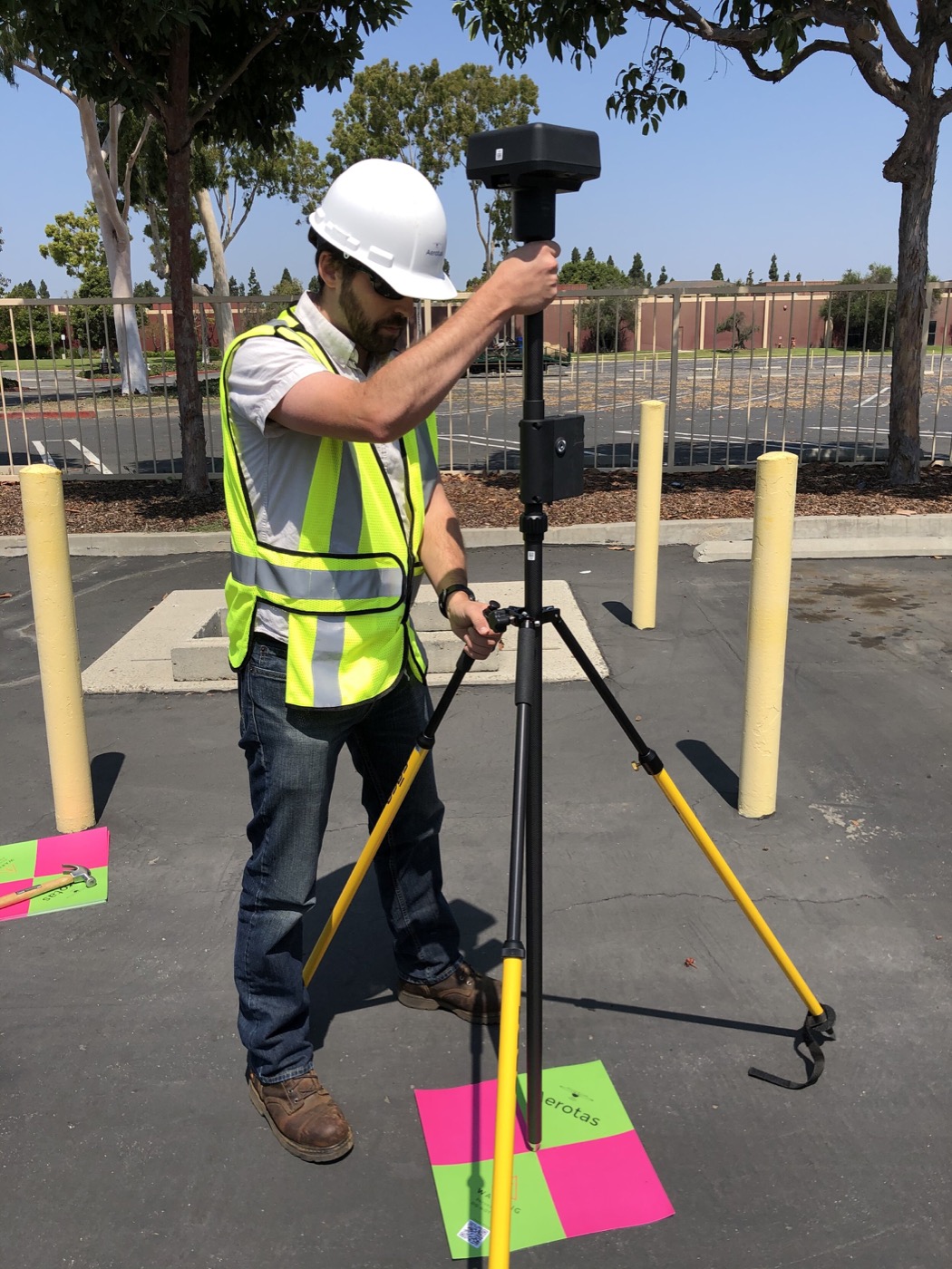 Surveyor carrying Aerotas ground control points in the field