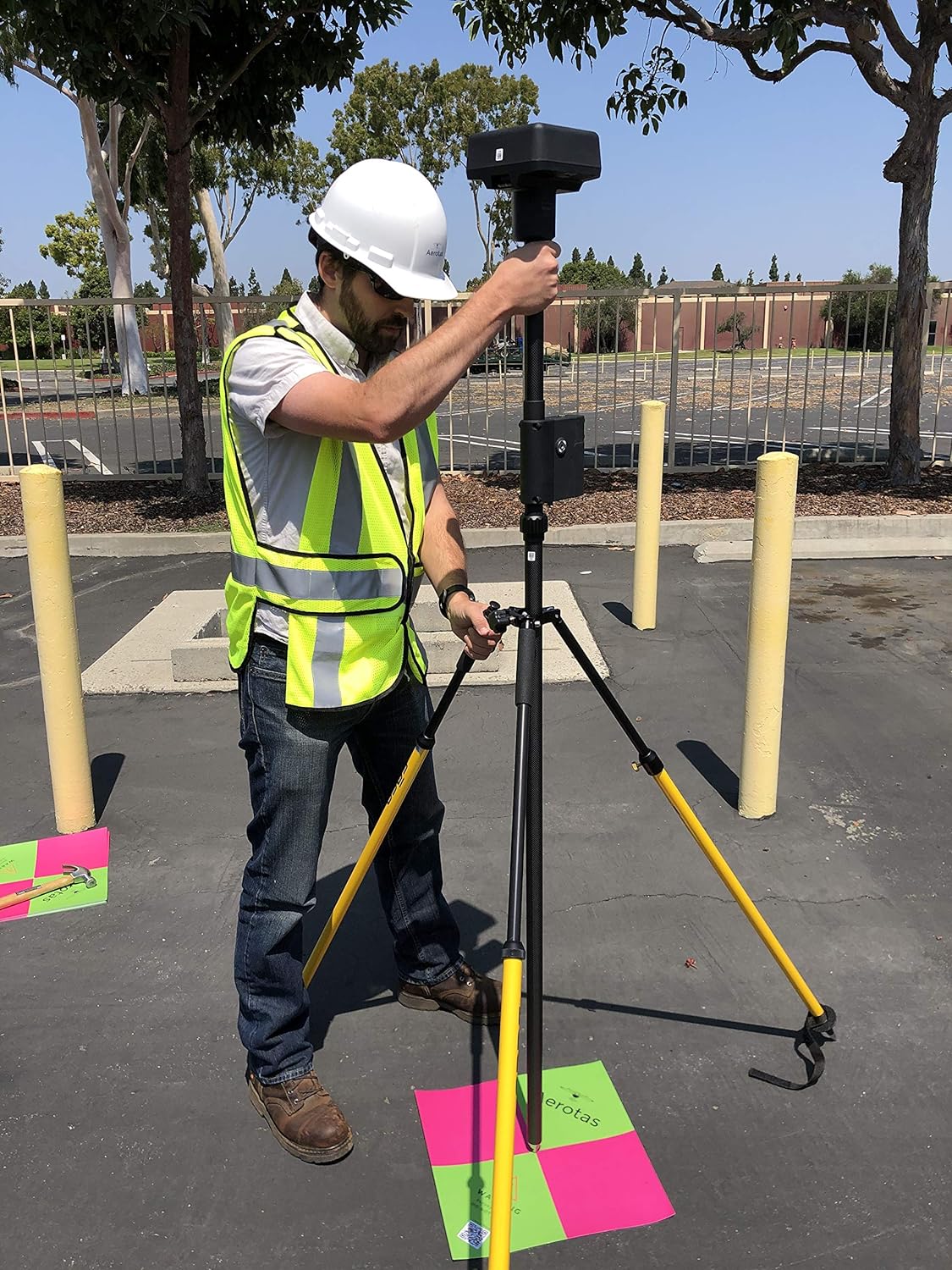 Surveyor setting up control and checkpoints for a drone mapping project.