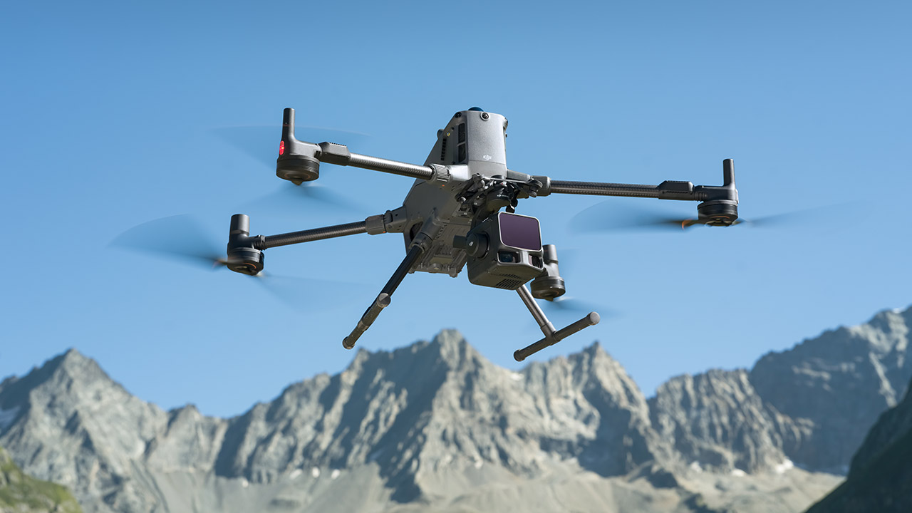 Large lidar-capable drone in flight above mountainous terrain.